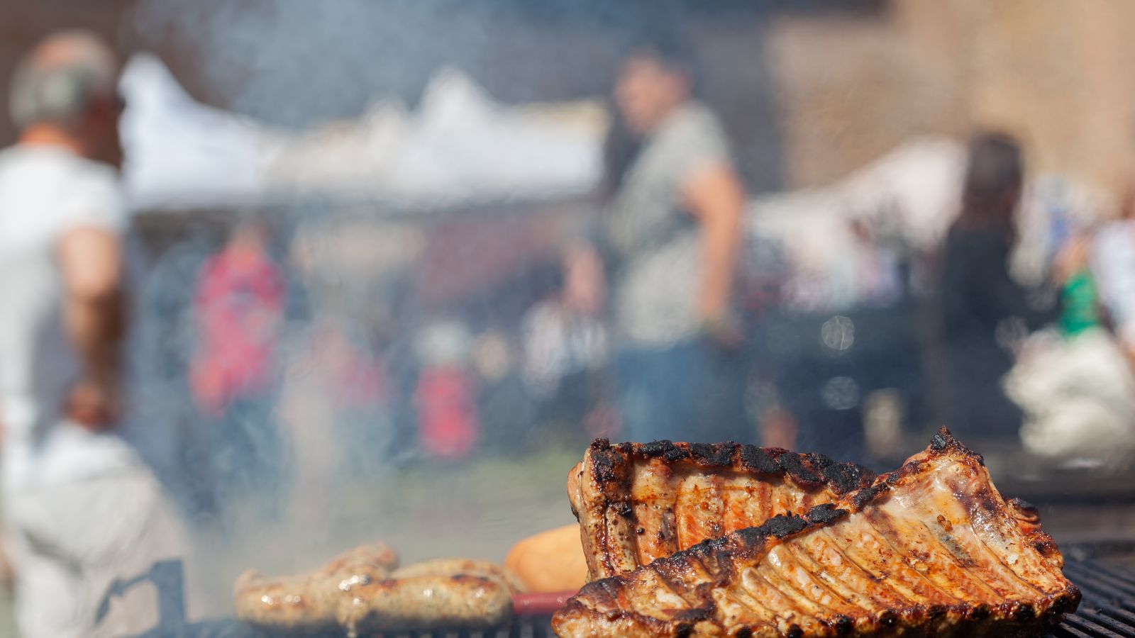 Rack of pork ribs smoking on a grill
